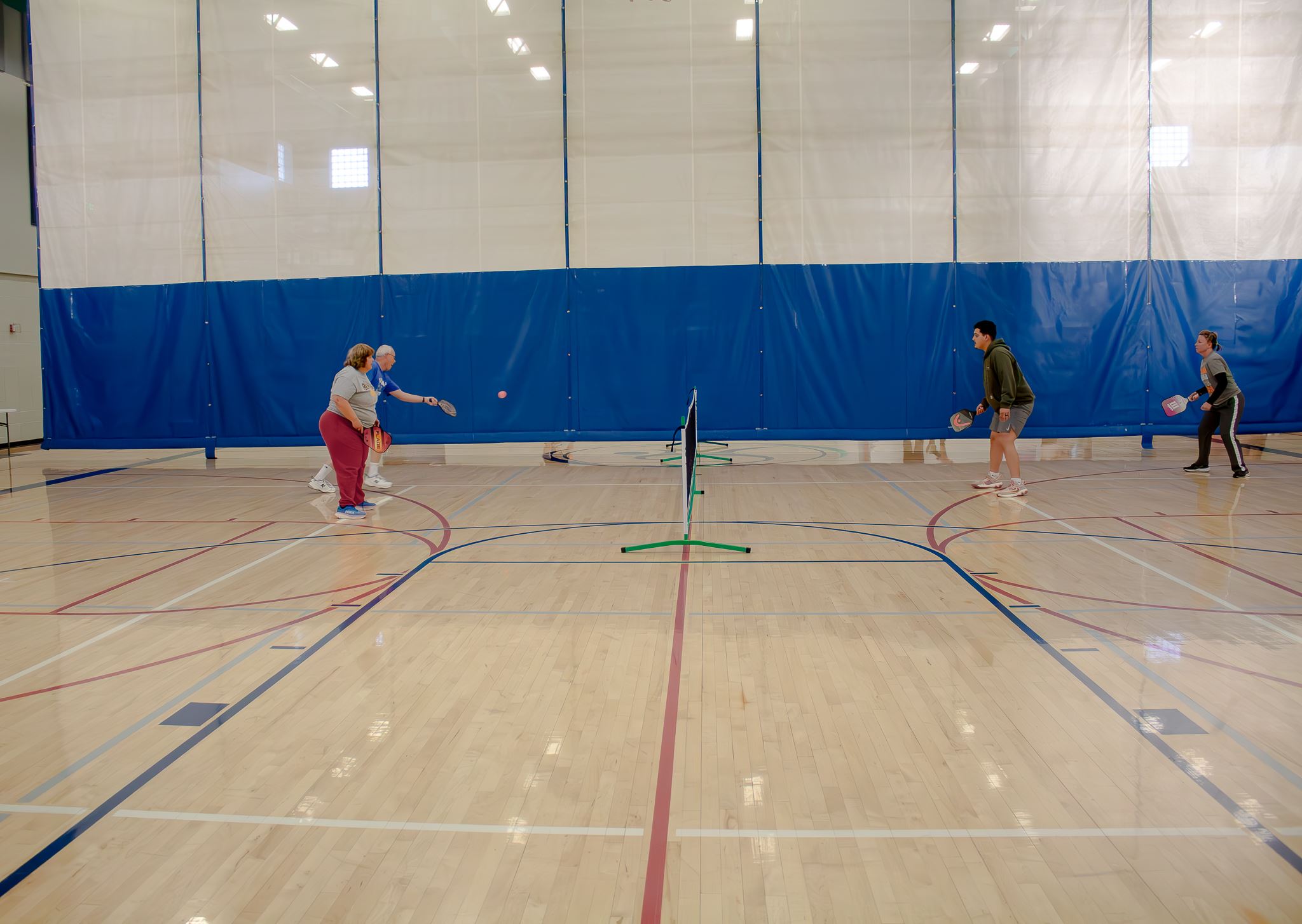 Two couples playing Pickleball in our Indoor Pickleball League